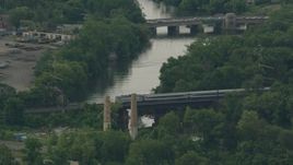 HD stock footage aerial video of tracking a commuter train crossing a river in Wilmington, Delaware Aerial Stock Footage | PP003_112