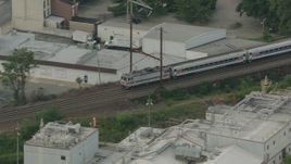HD stock footage aerial video tracking a passenger train cruising through Wilmington, Delaware Aerial Stock Footage | PP003_113