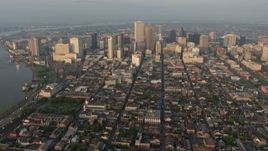4K aerial  video of tilt from French Quarter streets to reveal and approach Downtown at sunrise, New Orleans, Louisiana Aerial Stock Footage | PVED01_006