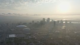4K aerial stock footage of Downtown New Orleans and Superdome with view of rising sun, Louisiana Aerial Stock Footage | PVED01_008