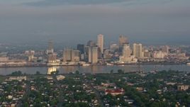 4K aerial stock footage of Downtown New Orleans skyline seen from across the Mississippi River at sunrise, Louisiana Aerial Stock Footage | PVED01_015