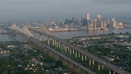 4K aerial stock footage orbit Crescent City Connection Bridge and Downtown New Orleans at sunrise, Louisiana Aerial Stock Footage | PVED01_016