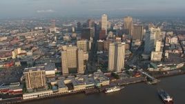 4K aerial stock footage fly over Mississippi River to approach Downtown New Orleans at sunrise, Louisiana Aerial Stock Footage | PVED01_023