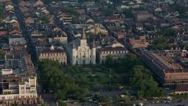 4K aerial stock footage reverse view of St. Louis Cathedral and Jackson Square in the French Quarter of New Orleans at sunrise, Louisiana Aerial Stock Footage | PVED01_035
