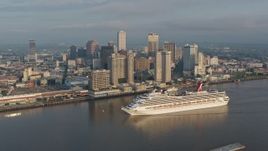 4K aerial stock footage orbit a Carnival Cruise ship sailing by Downtown New Orleans at sunrise, Louisiana Aerial Stock Footage | PVED01_037