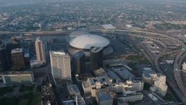 4K aerial stock footage orbiting the Superdome in Downtown New Orleans, Louisiana at sunrise Aerial Stock Footage | PVED01_041