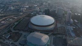 4K aerial stock footage of the Superdome and New Orleans Arena in Downtown New Orleans, Louisiana at sunrise Aerial Stock Footage | PVED01_043