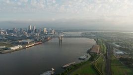 4K aerial stock footage of Crescent City Connection Bridge at sunrise spanning the Mississippi River, New Orleans, Louisiana Aerial Stock Footage | PVED01_044