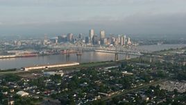 4K aerial stock footage wide orbit of Crescent City Connection and Downtown New Orleans at sunrise seen from Gretna, Louisiana Aerial Stock Footage | PVED01_045