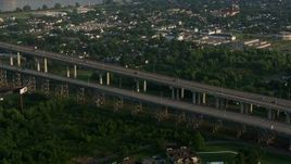 4K aerial stock footage flyby Crescent City Connection Bridge and reveal Downtown New Orleans skyline at sunrise, Louisiana Aerial Stock Footage | PVED01_046E