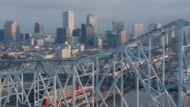 4K aerial stock footage flyby the Crescent City Connection Bridge, reveal Downtown New Orleans skyline at sunrise, Louisiana Aerial Stock Footage | PVED01_047