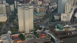 4K aerial stock footage orbit Downtown New Orleans skyscraper to reveal Harrah's New Orleans Casino at sunrise, Louisiana Aerial Stock Footage | PVED01_051