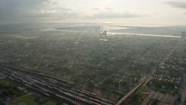 4K aerial stock footage fly over Upper Ninth Ward toward factory by the Canal at sunrise, New Orleans, Louisiana Aerial Stock Footage | PVED01_058E