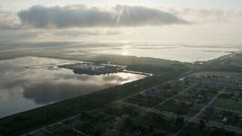 4K aerial stock footage fly over Lower Ninth Ward Neighborhoods toward water treatment plant at sunrise in New Orleans, Louisiana Aerial Stock Footage | PVED01_061
