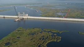 4K aerial stock footage pan across surge barrier and orbit a gate at sunrise in St. Bernard Parish bayou, Louisiana Aerial Stock Footage | PVED01_076
