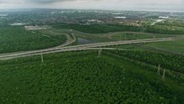 4K aerial stock footage fly over freeway interchange to approach a New Orleans East suburb at sunrise, Louisiana Aerial Stock Footage | PVED01_084E