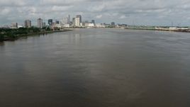 4K aerial stock footage fly low over Mississippi River to approach Downtown New Orleans skyline, Louisiana Aerial Stock Footage | PVED01_128