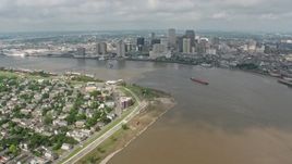 4K aerial stock footage fly over Mississippi River and skyscrapers in Downtown New Orleans to reveal Superdome, Louisiana Aerial Stock Footage | PVED01_143E