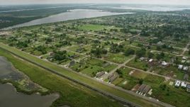 4K aerial stock footage urban neighborhood and canal in Lower Ninth Ward, tilt to reveal industrial area on Industrial Canal, Louisiana Aerial Stock Footage | PVED01_165E