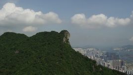 5K stock footage aerial video approach rocky summit with apartment buildings in distance in Kowloon, Hong Kong Aerial Stock Footage | SS01_0001