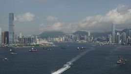 5K stock footage aerial video fly over Victoria Harbor to approach skyscrapers in Kowloon and Hong Kong Island in China Aerial Stock Footage | SS01_0010