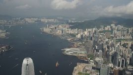 5K stock footage aerial video of Victoria Harbor and waterfront convention center on Hong Kong Island, China Aerial Stock Footage | SS01_0044