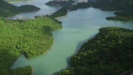 5K stock footage aerial video fly over reservoir and tilt to reveal dam and apartment buildings by harbor on Hong Kong Island, China Aerial Stock Footage | SS01_0064