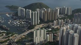 5K stock footage aerial video of waterfront apartment buildings and small bridge over Aberdeen Harbor on Hong Kong Island, China Aerial Stock Footage | SS01_0080