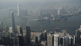 5K stock footage aerial video approach harbor from Hong Kong Island and pan across the water and Kowloon shoreline, China Aerial Stock Footage | SS01_0083