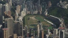 5K stock footage aerial video of race track on Hong Kong Island ringed by skyscrapers in China Aerial Stock Footage | SS01_0101