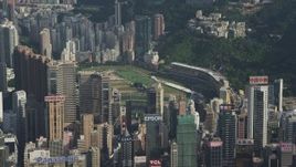 5K stock footage aerial video fly away from skyscrapers around a race track on Hong Kong Island, China Aerial Stock Footage | SS01_0102