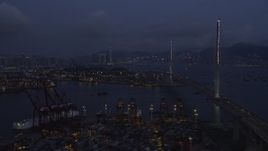 5K stock footage aerial video fly over containers at the Port of Hong Kong toward center of Stonecutters Bridge at night in China Aerial Stock Footage | SS01_0115