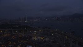 5K stock footage aerial video fly over Port of Hong Kong to approach Kowloon and Hong Kong Island at night, China Aerial Stock Footage | SS01_0119