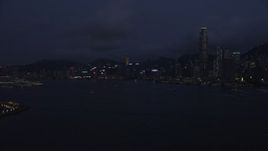 5K stock footage aerial video approach the Hong Kong Island skyline from Victoria Harbor at night, China Aerial Stock Footage | SS01_0128