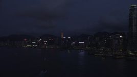 5K stock footage aerial video approach Hong Kong Island skyscrapers along the harbor at night, China Aerial Stock Footage | SS01_0130