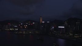 5K stock footage aerial video approach Hong Kong Island skyscrapers and convention center at night, China Aerial Stock Footage | SS01_0132