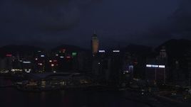 5K stock footage aerial video approach skyscrapers and convention center on Hong Kong Island at night, China Aerial Stock Footage | SS01_0133