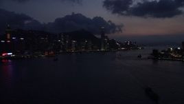 5K stock footage aerial video of approaching Hong Kong Island and Victoria Harbor at nighttime, China Aerial Stock Footage | SS01_0140