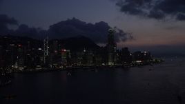 5K stock footage aerial video of approaching the Hong Kong Island skyline from Victoria Harbor at night, China Aerial Stock Footage | SS01_0143