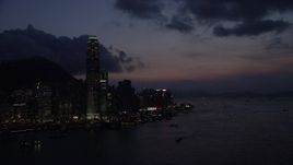 5K stock footage aerial video pan across the Hong Kong Island skyline and approach the shore at night in China Aerial Stock Footage | SS01_0145