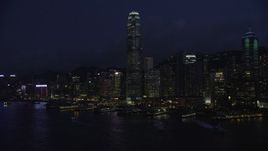 5K stock footage aerial video approach International Finance Centre and piers on Hong Kong Island at night, China Aerial Stock Footage | SS01_0147