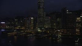 5K stock footage aerial video approach piers on Hong Kong Island near skyscrapers at night in China Aerial Stock Footage | SS01_0148