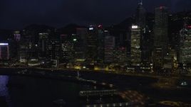 5K stock footage aerial video flyby colorful lights on waterfront Hong Kong Island skyscrapers at night in China Aerial Stock Footage | SS01_0150