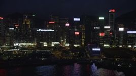 5K stock footage aerial video of high-rises and office buildings lining the harbor on Hong Kong Island at nighttime, China Aerial Stock Footage | SS01_0154