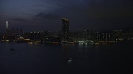 5K stock footage aerial video approach Harbourfront Landmark skyscrapers in Kowloon, Hong Kong at night, China Aerial Stock Footage | SS01_0156