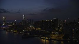 5K stock footage aerial video of waterfront apartment buildings overlooking the harbor at night in Kowloon, Hong Kong, China Aerial Stock Footage | SS01_0159