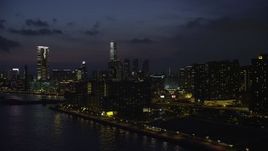 5K stock footage aerial video of waterfront apartment buildings and view of tall towers at night in Kowloon, Hong Kong, China Aerial Stock Footage | SS01_0160