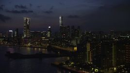 5K stock footage aerial video of waterfront hotels near The Masterpiece skyscrapers at night in Kowloon, Hong Kong, China Aerial Stock Footage | SS01_0161