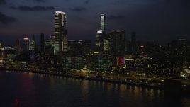 5K stock footage aerial video flyby waterfront hotels with blinking lights near The Masterpiece tower at night in Kowloon, Hong Kong, China Aerial Stock Footage | SS01_0162