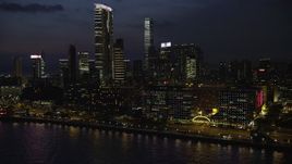 5K stock footage aerial video of hotel overlooking the harbor near The Masterpiece at night in Kowloon, Hong Kong, China Aerial Stock Footage | SS01_0163